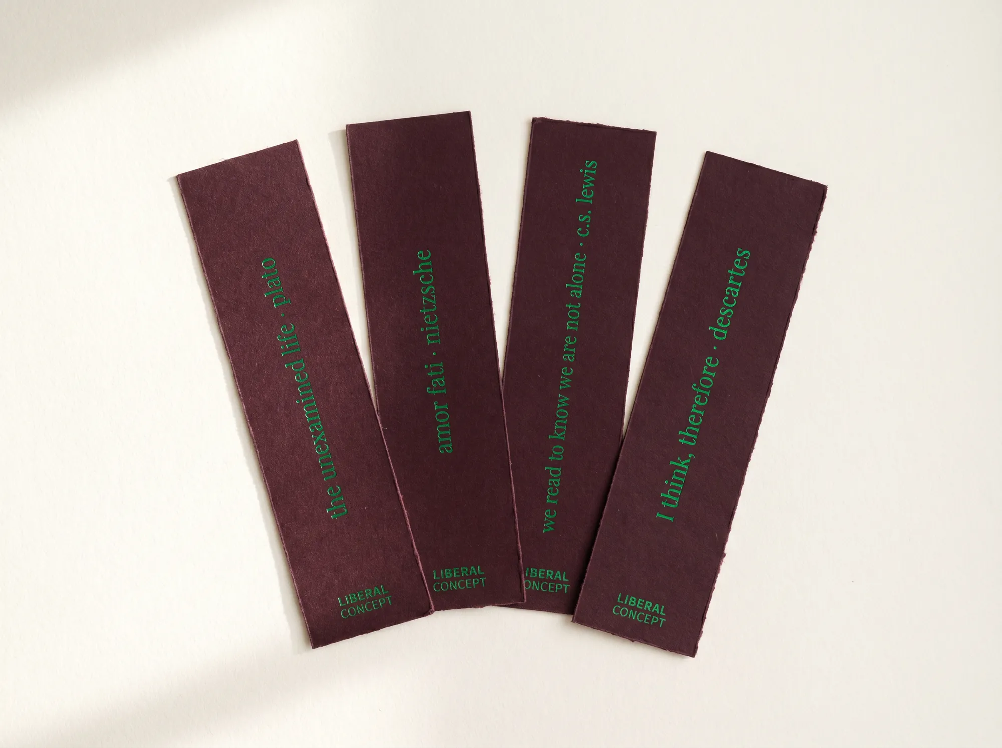 Liberal Concept Bookmark Set (Fine Stationery & Reading Tools) — A four-piece set of long bookmarks cut from deep wine cardstock and printed with one canonical citation each. Replaces the paper sleeve with a usable object.
