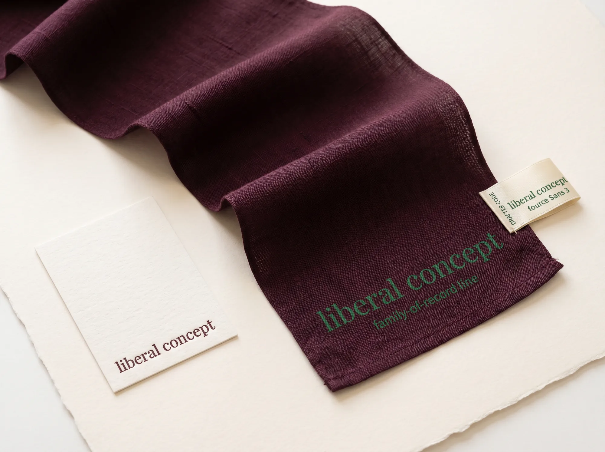 Liberal Concept Family Silk Scarf (Legacy & Estate Letter Practice) — A long hand-loomed silk family scarf in deep wine with the wordmark hand-printed in forest green at one end — a working accessory issued to working family members and named drafters at the working ratification.